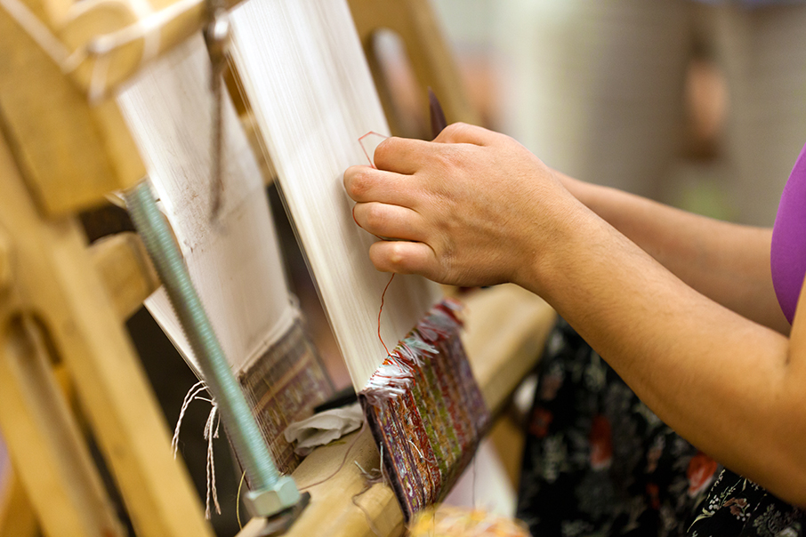 the Turkish woman knitting the silk carpet
